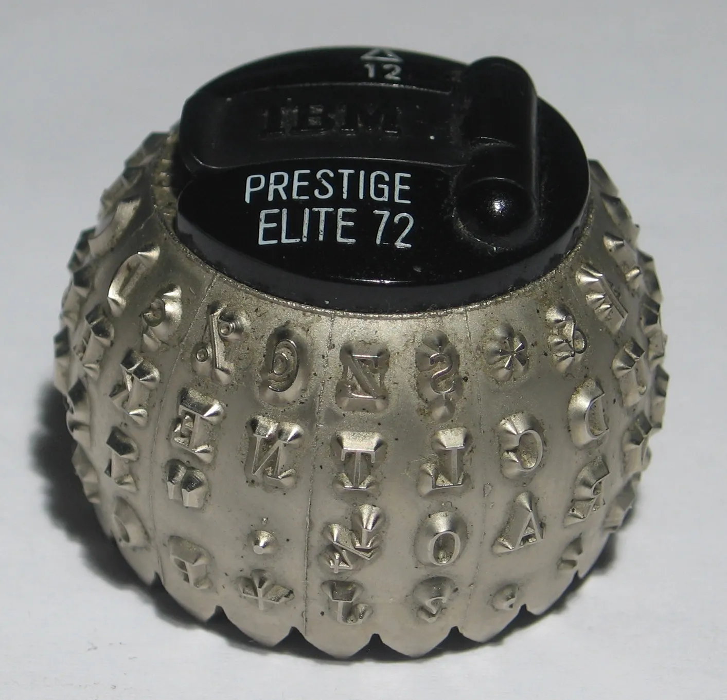 Close-up of an IBM Selectric typeball, the rotating spherical element that carried all 88 characters and replaced 44 individual typebars